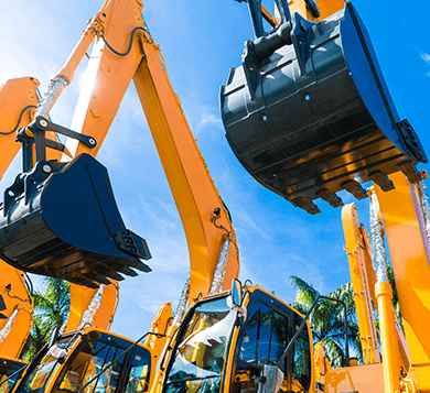 Heavy-duty yellow excavators with raised buckets under a bright blue sky, representing construction equipment and machinery for rent or industrial use.